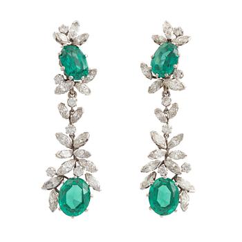569. A pair of 18K white gold earrings set with round brilliant- and navette-cut diamonds and green synthetic stones.