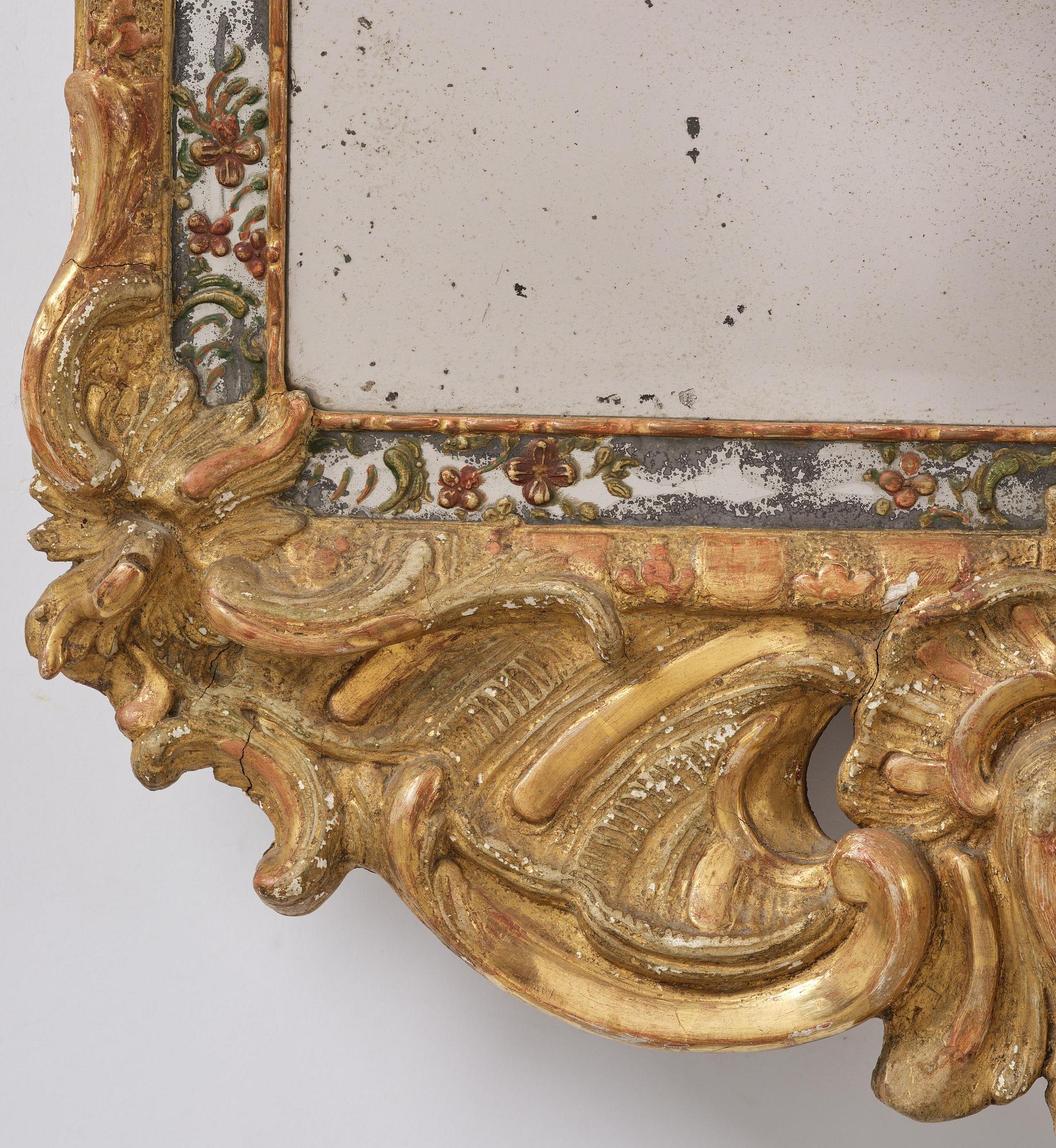 A Swedish giltwood and polychrome-painted Rococo mirror, later part of the 18th century.