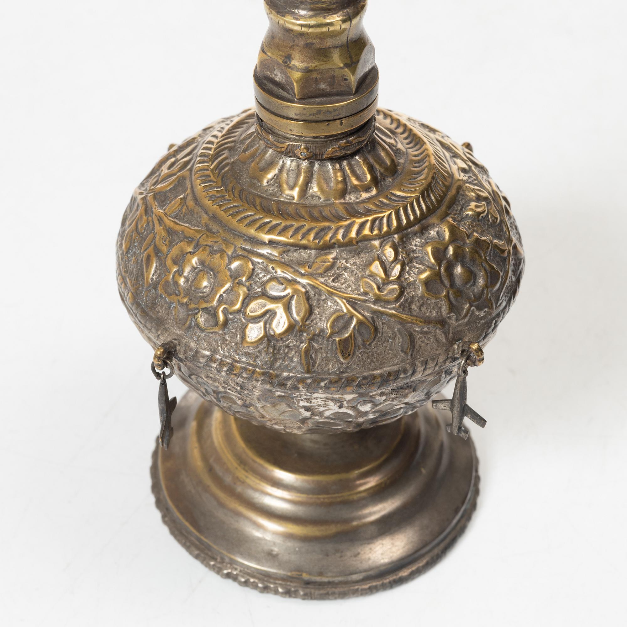 An 20th century british Raj repoussé metal rosewater sprinkler.