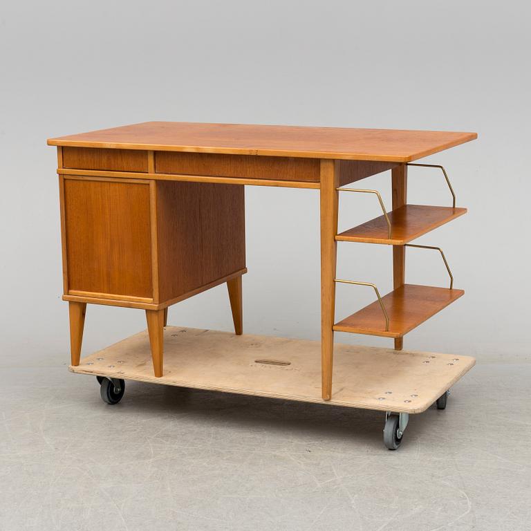 A teak veneered desk, 1950's.