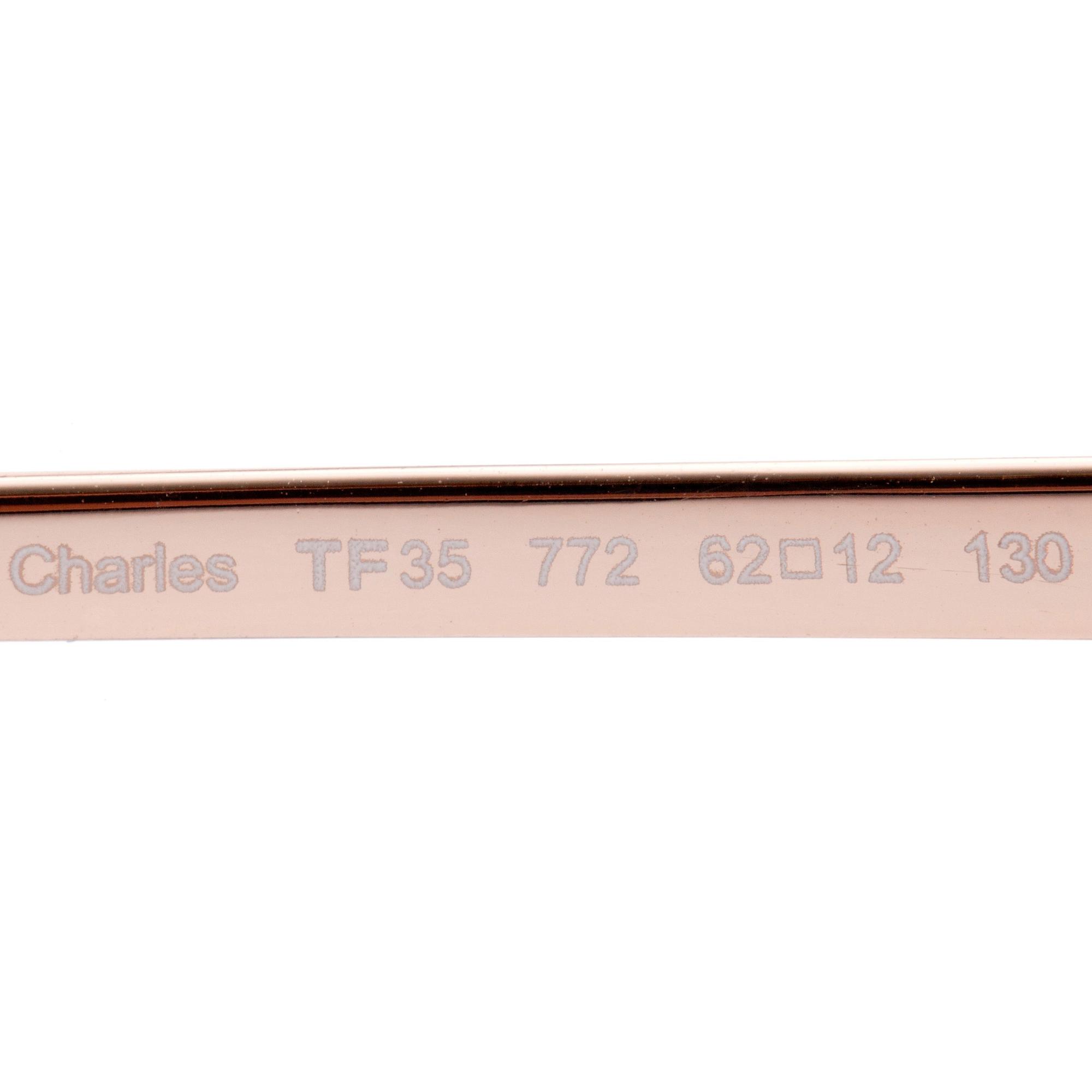 TOM FORD, a pair of gold colored sunglasses.