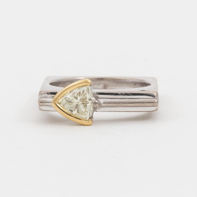 A ring set with a trilliant-cut diamond and small round, brilliant-cut diamonds.