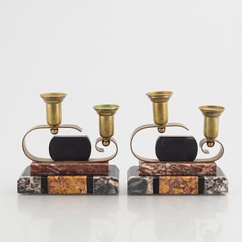 A pair of Art Déco marble and brass two-branch candlesticks, 1920's/30's.