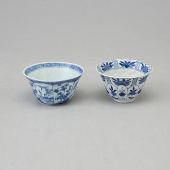 Two blue and white dishes and two cups with dishes, Qing dynasty, Qianlong (1736-95) and Kangxi (1662-1722).