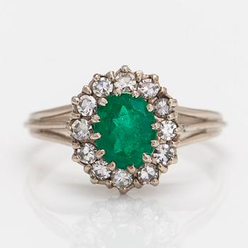 A 14K white gold ring, with an emerald and single-cut diamonds. Finnish import marks.