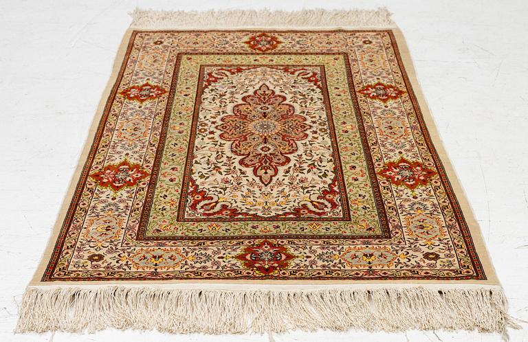 A Hereke silk rug, West Anatolia, c. 107 x 69 cm.