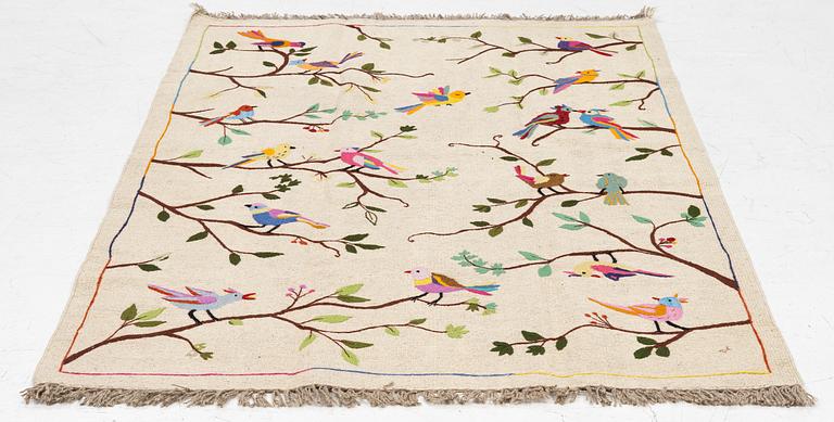 A hand-embroidered kelim rug, c. 183 x 125 cm.