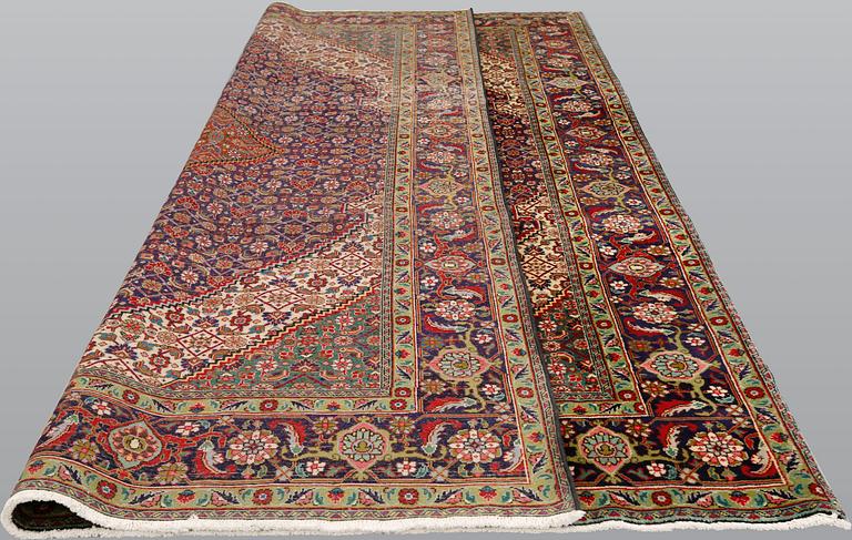 A Tabriz carpet, approximately 360 x 255 cm.