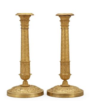 681. A pair of French Empire early 19th Century candlesticks.