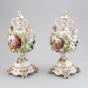 A pair of enamelled earthenware vases with covers, 20th century.