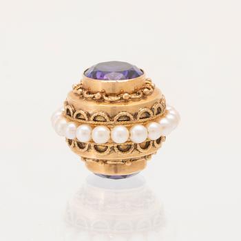 An 18K gold pendant set with synthetic colourchange purple sapphires and cultured pearls.