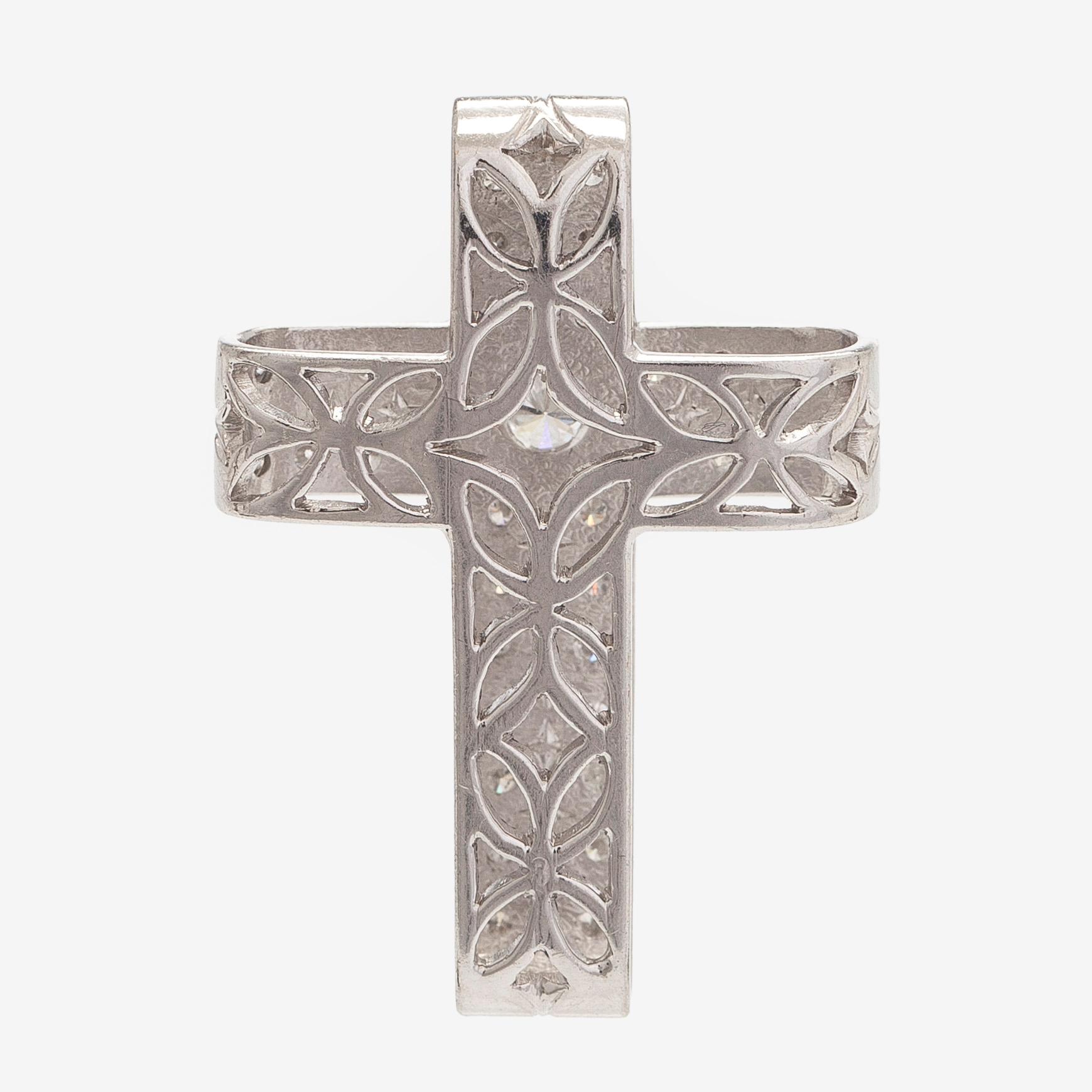 An 18K white gold cross pendant with diamonds.