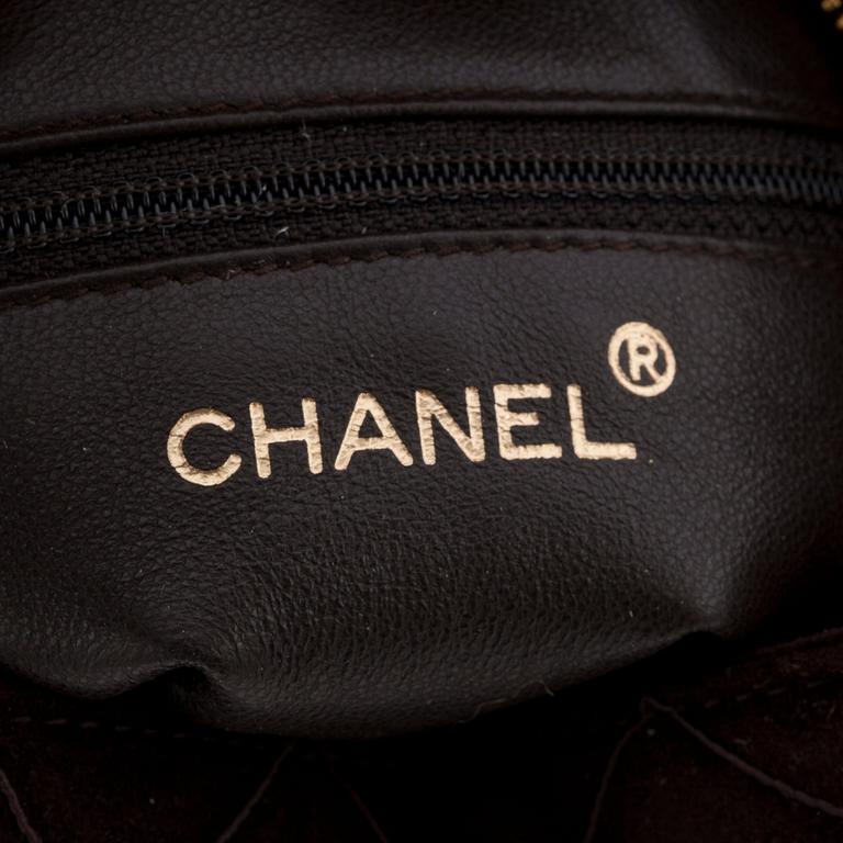 CHANEL, a brown suede cross body bag.