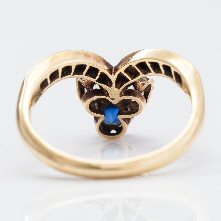 A 14K gold ring with a synthetic sapphire, radiant-cut diamonds ca. 0.28 ct in total and rose cut diamonds.