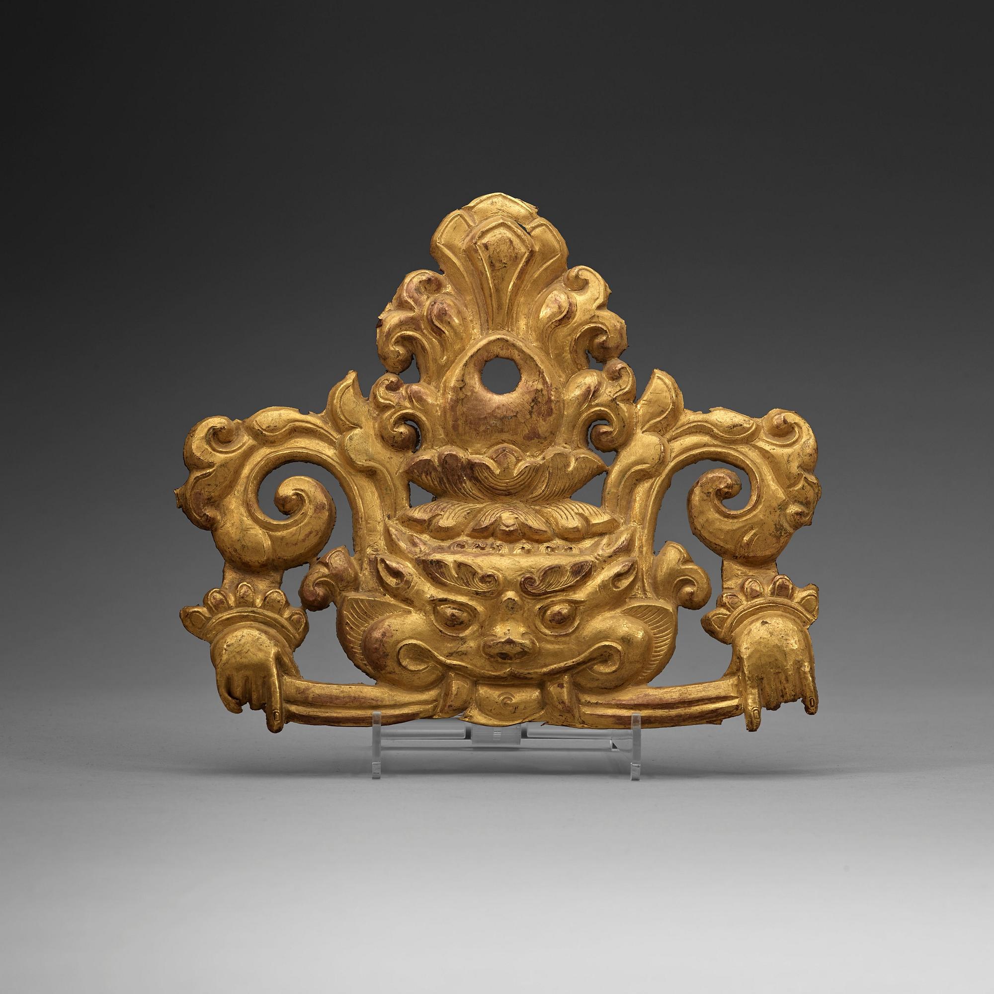A Tibetan gilt metal ornament, 19th Century.