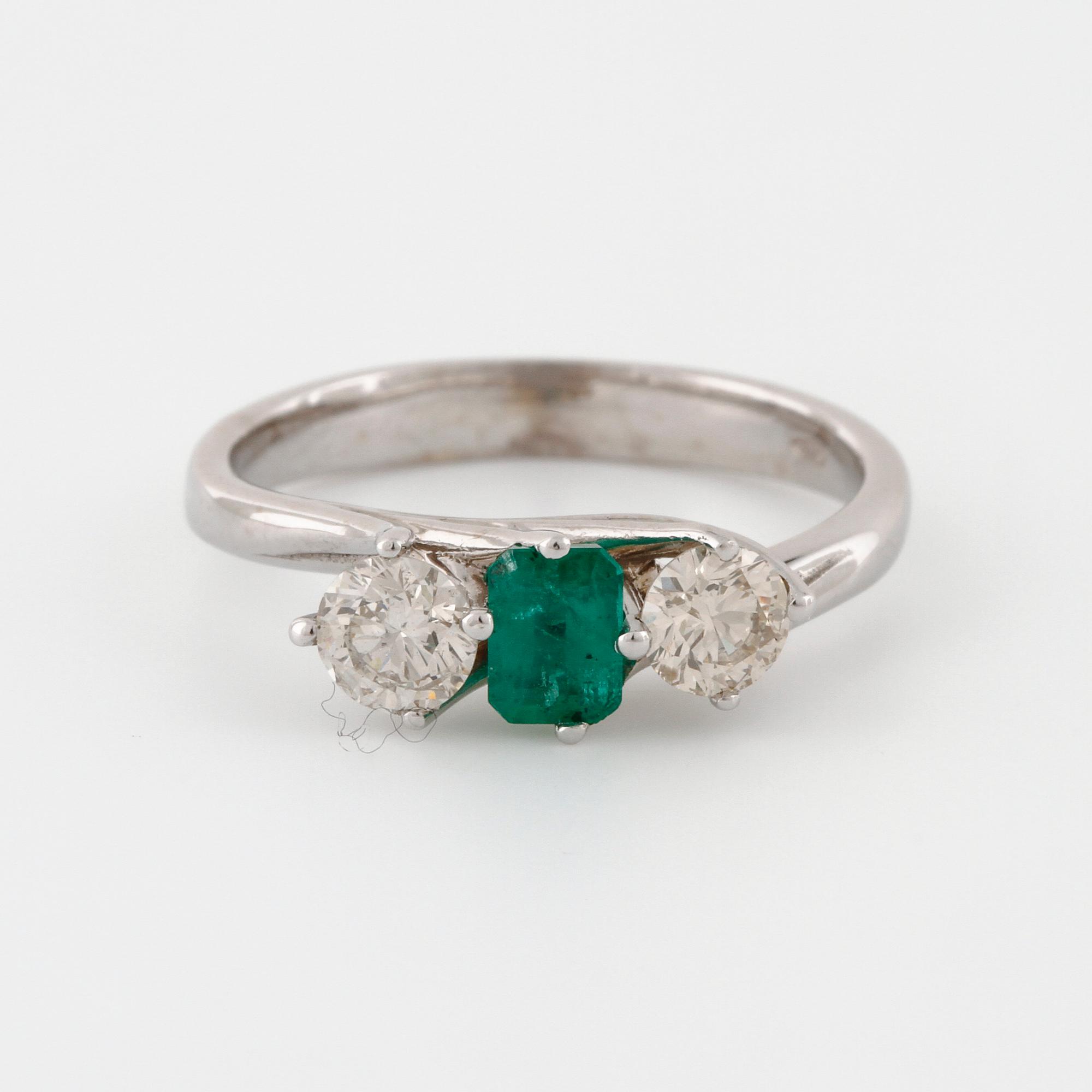 A emerald and brilliant cut diamond ring.