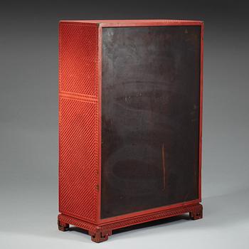 A well carved cinnaber lacquer 'Kang' cabinet, Qing dynasty, 18th Century.