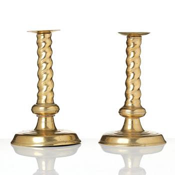 A pair of Northern European cast brass baroque candlesticks, circa 1700.
