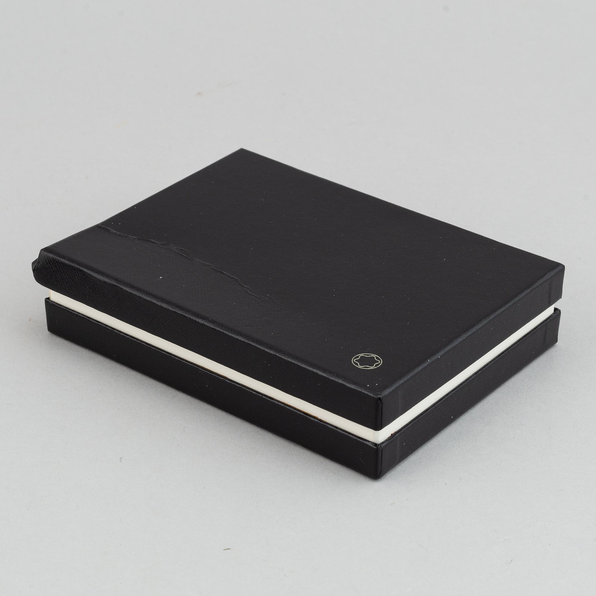 MOntblanc, a ball point pen and leather passport holder.