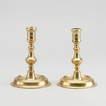 A set of two of brass candle sticks mid 18th century.