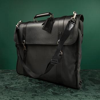 A Garment bag by Louis Vuitton.