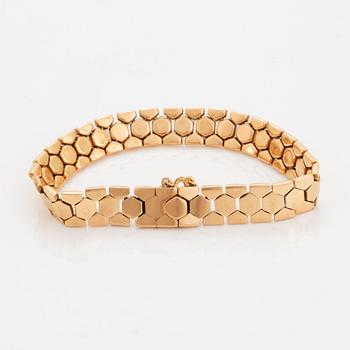 An 18K gold bracelet.