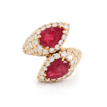 An 18K gold ring set with two facted rubies and round brilliant-cut diamonds.