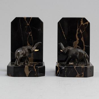 a pair of bronze and stone bookends from the first half of the 20th century.