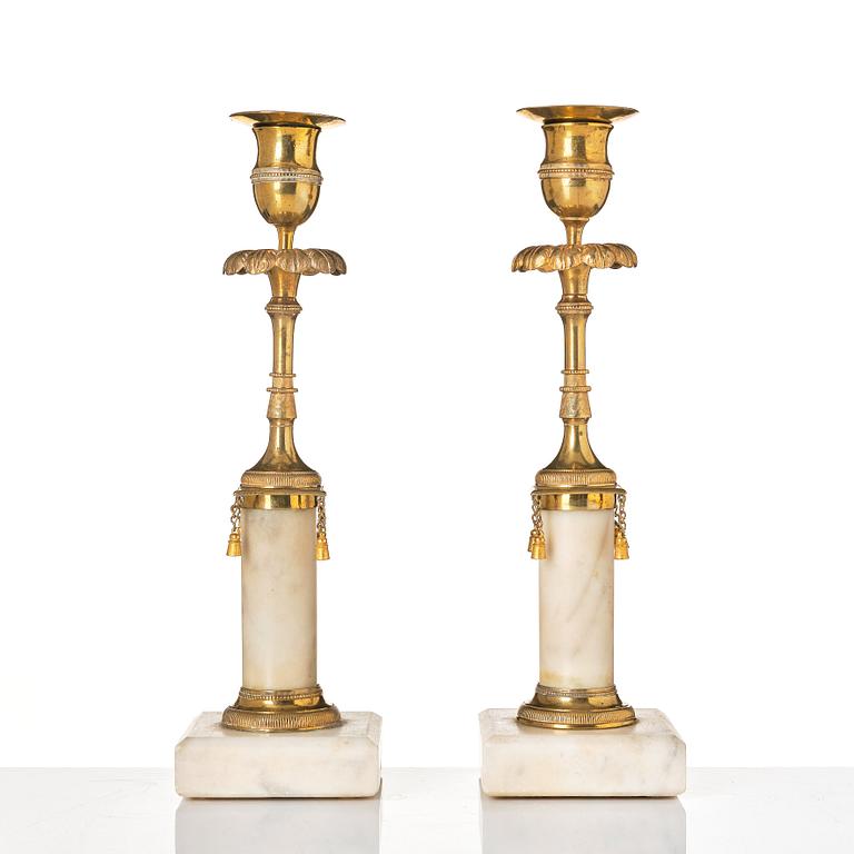 A pair of late Gustavian marble and bronze candlesticks.