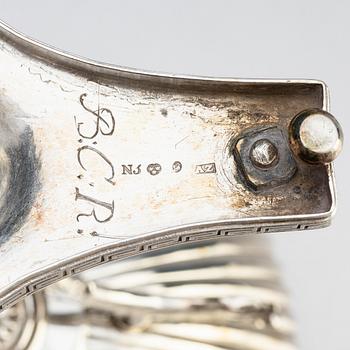 A Swedish Empire silver sugar bowl with lid and a suger sprinkle spoon, marks of Adolf Zethelius, Stockholm 1819.