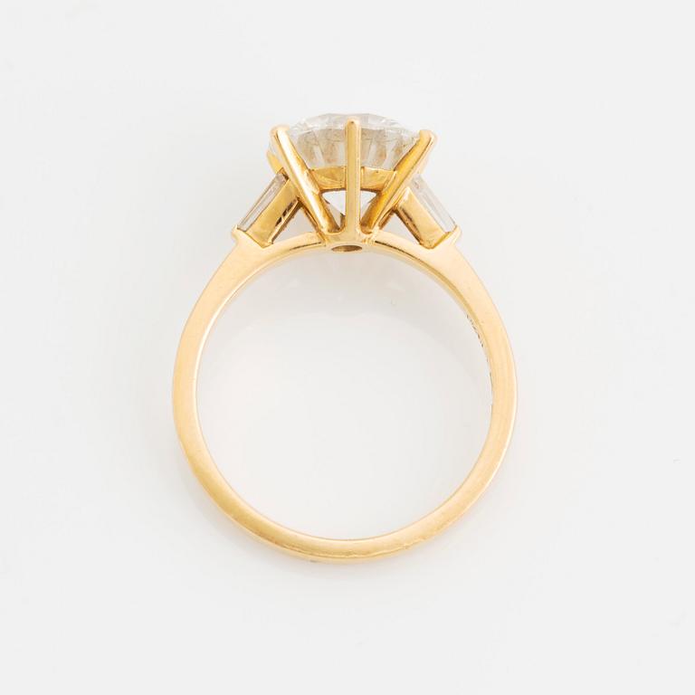 An 18K gold ring set with a round brilliant-cut diamond weight 3.30 cts quality E vs2.