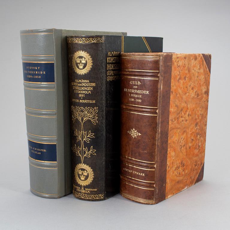 Three volumes of art and silver books.