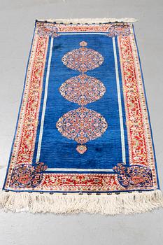 A rug, silk Hereke, ca 143 x 63,5 cm.
