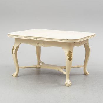 A dining table and six chairs, rococo style, mid 20th century.