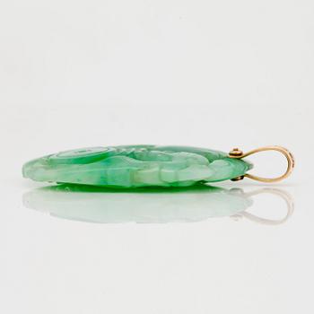 A carved jadeite pendant and earrings.