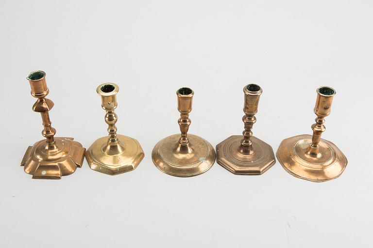 A set of five different brass late Baroque candlesticks.