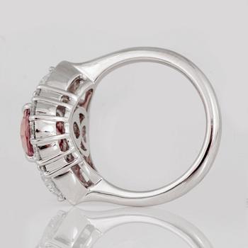 An untreated padparascha (orangy pink sapphire) and diamond ring.