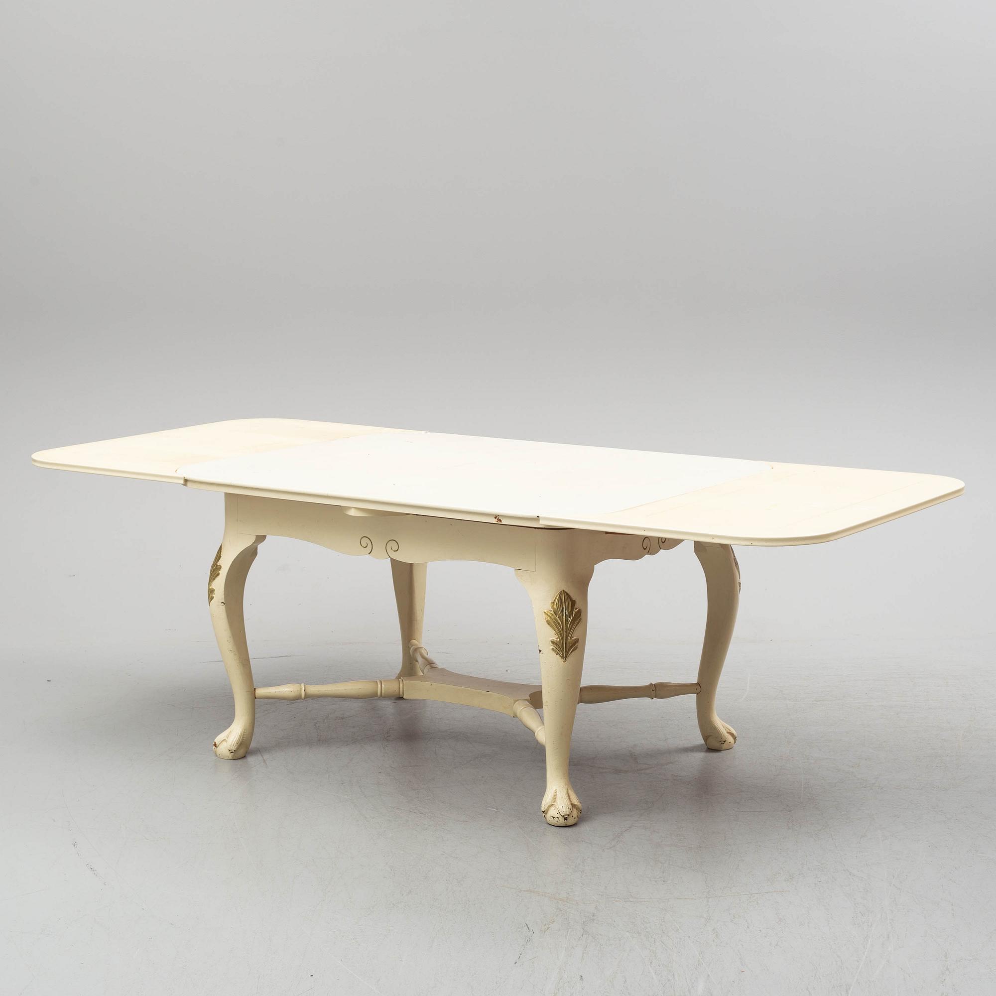 A dining table and six chairs, rococo style, mid 20th century.