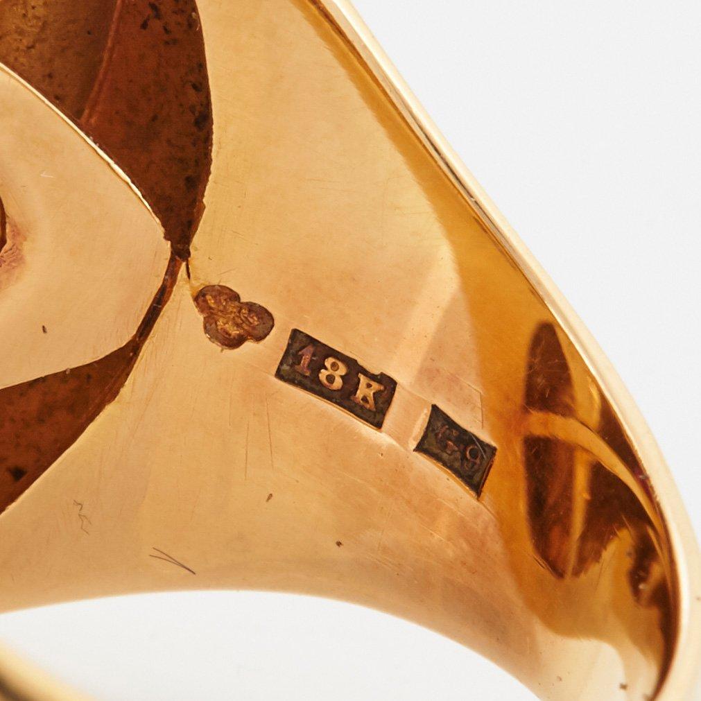 A Sigurd Persson 18K gold ring set with a faceted garnet.