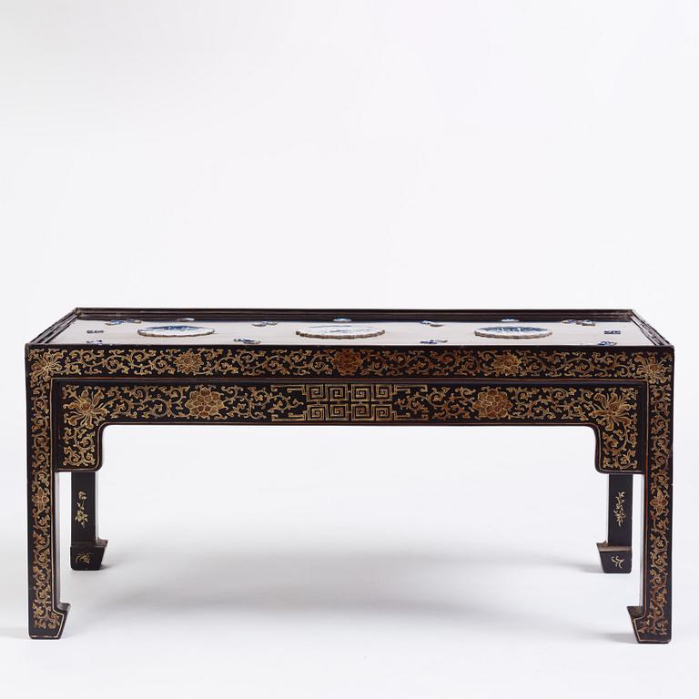 A Chinese black lacquered table with porcelain placques, presumably first half of the 20th century.