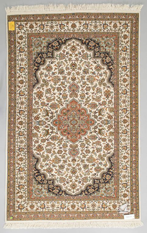 A Kashmir silk carpet. Circa 221 x 136 cm.