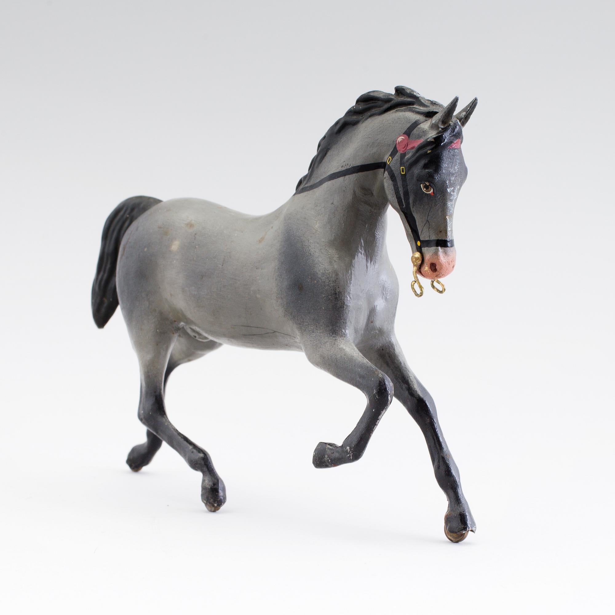 A painted tinplate toy horse ca year 1900.