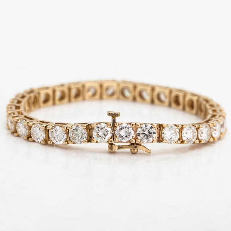 A 14K gold tennis bracelet, with brilliant-cut diamonds totalling approximately 12.00 ct.