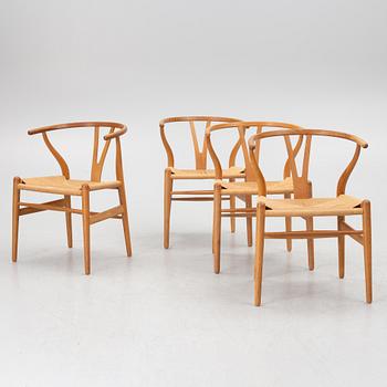 Hans J. Wegner, four model CH-24/ 'Wishbone' chairs, Carl Hansen, Odense, Denmark, second half of the 20th century.