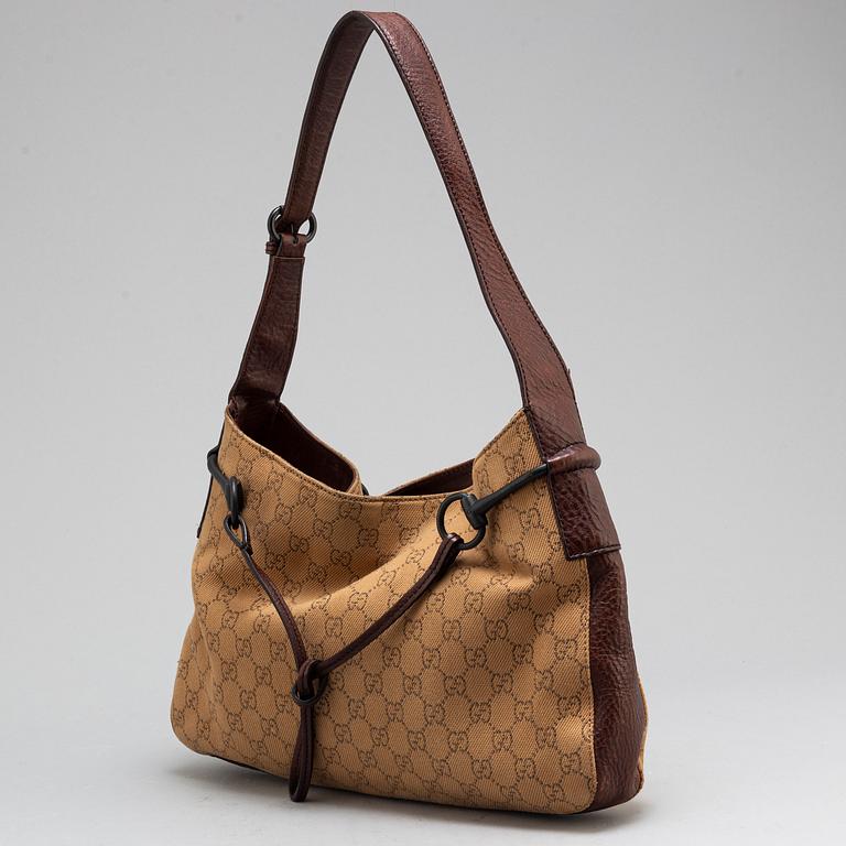 GUCCI, A canvas and leather bag.