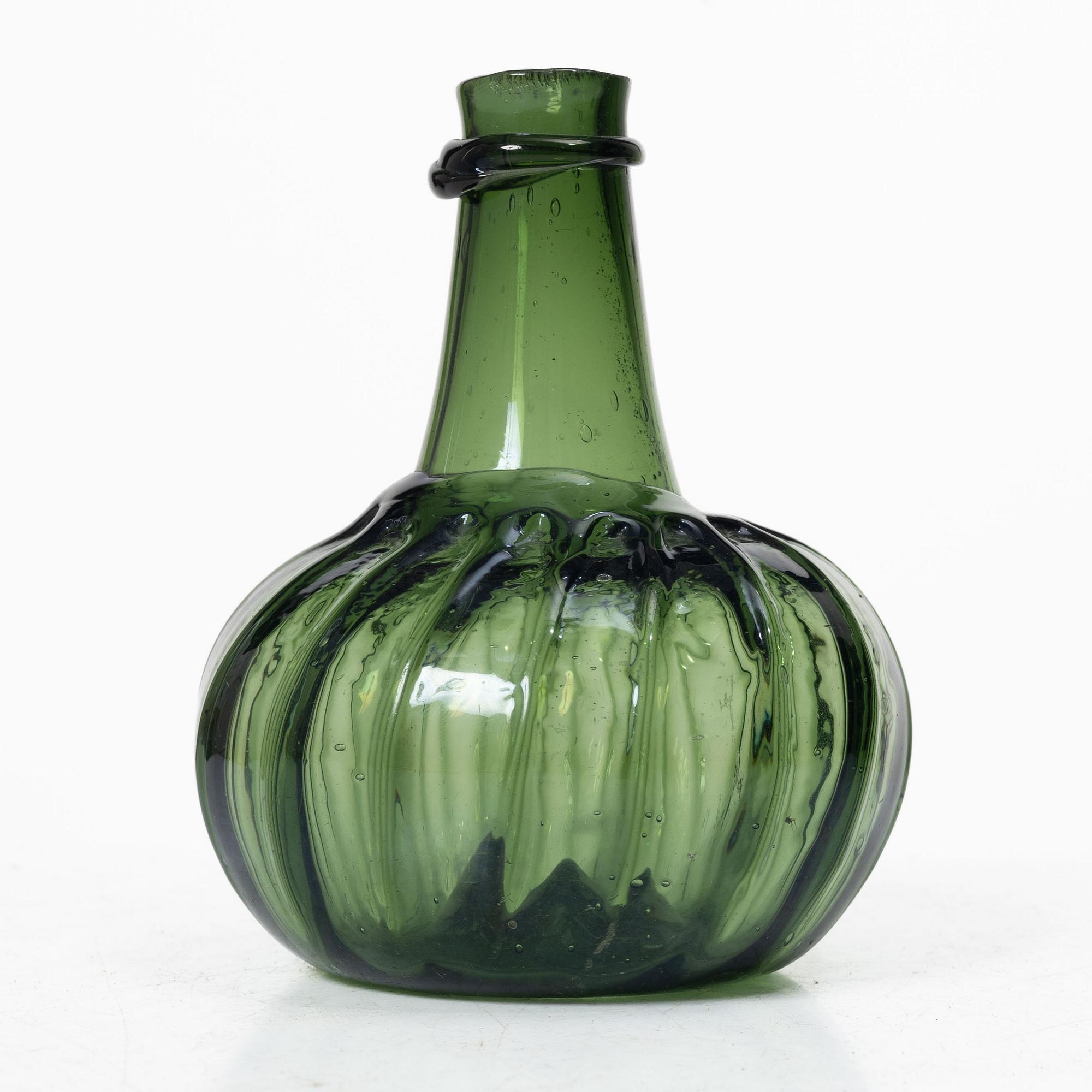 A green twisted glass bottle, 18th century.