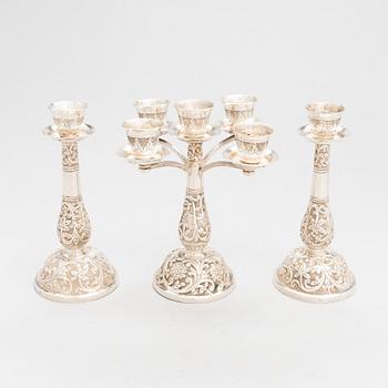 A silver candelabrum and a pair of candlesticks, presumably Persia mid-20th century/latter half of the 20th cent.