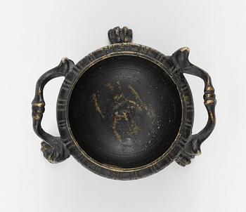 A bronze salt cellar.