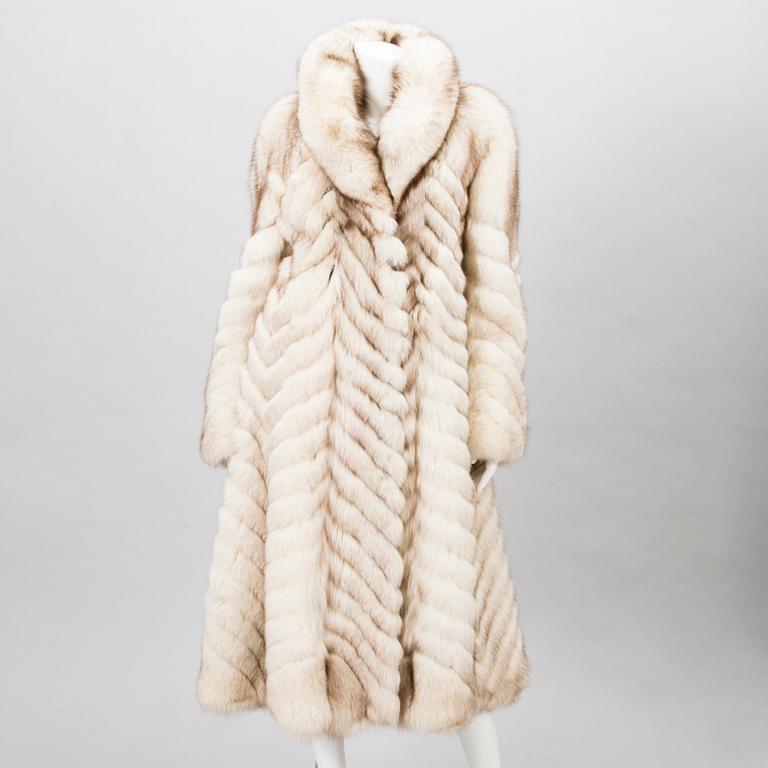 Off-white fox fur coat.