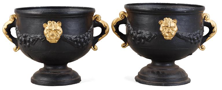 A pair of Baroque style 19th century iron cast garden urns.